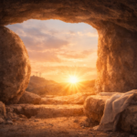Sunrise shining through the entrance of an empty tomb, with the stone rolled away and soft golden light illuminating the scene.